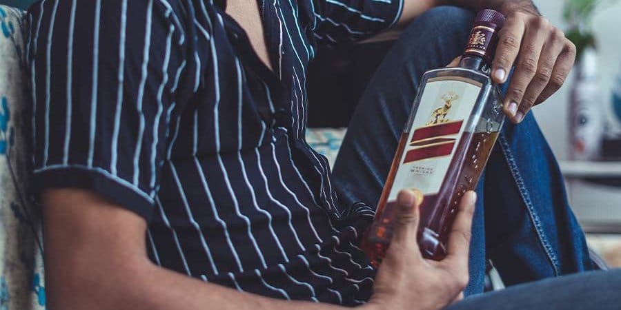 man holding a bottle of alcohol