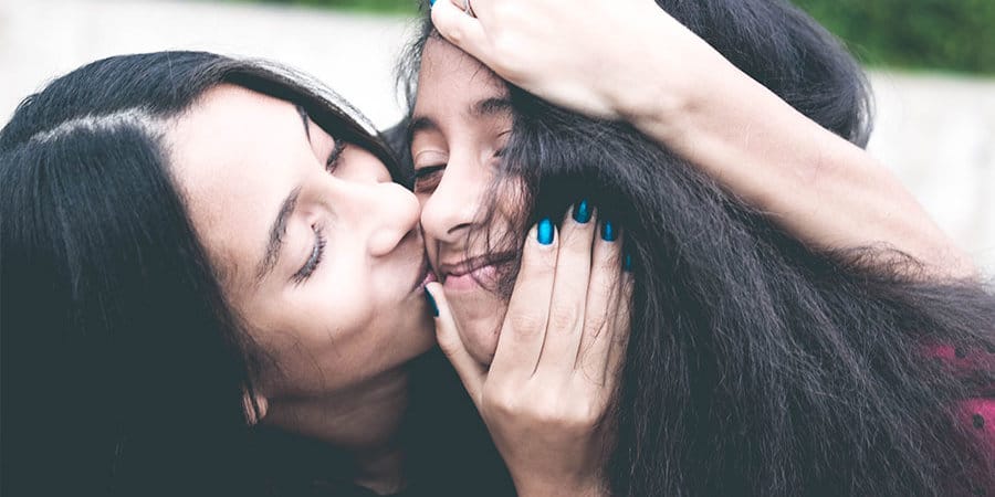 mother embracing her daughter