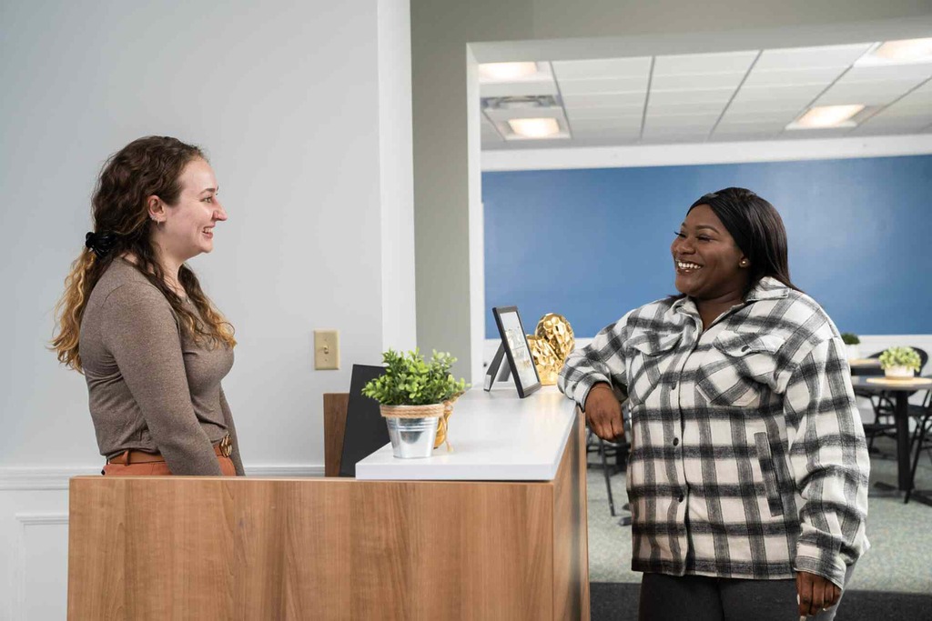 Woman is greeted by Harmony Health Group staff.